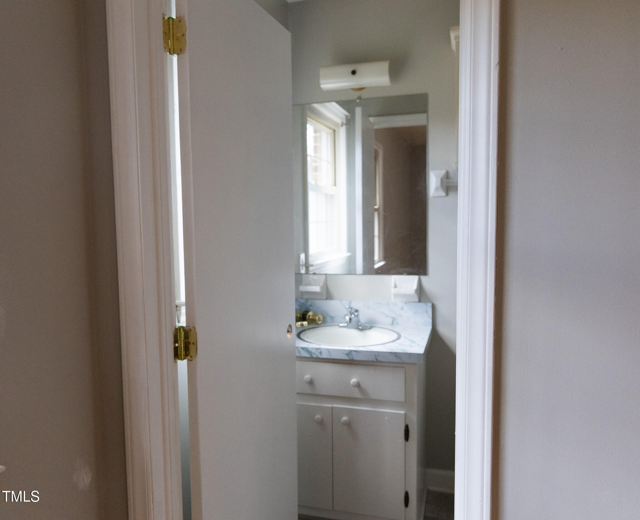 3212 Sparger Road Durham, NC 27705 - Photo 35 of 57 a bathroom with a sink and a mirror