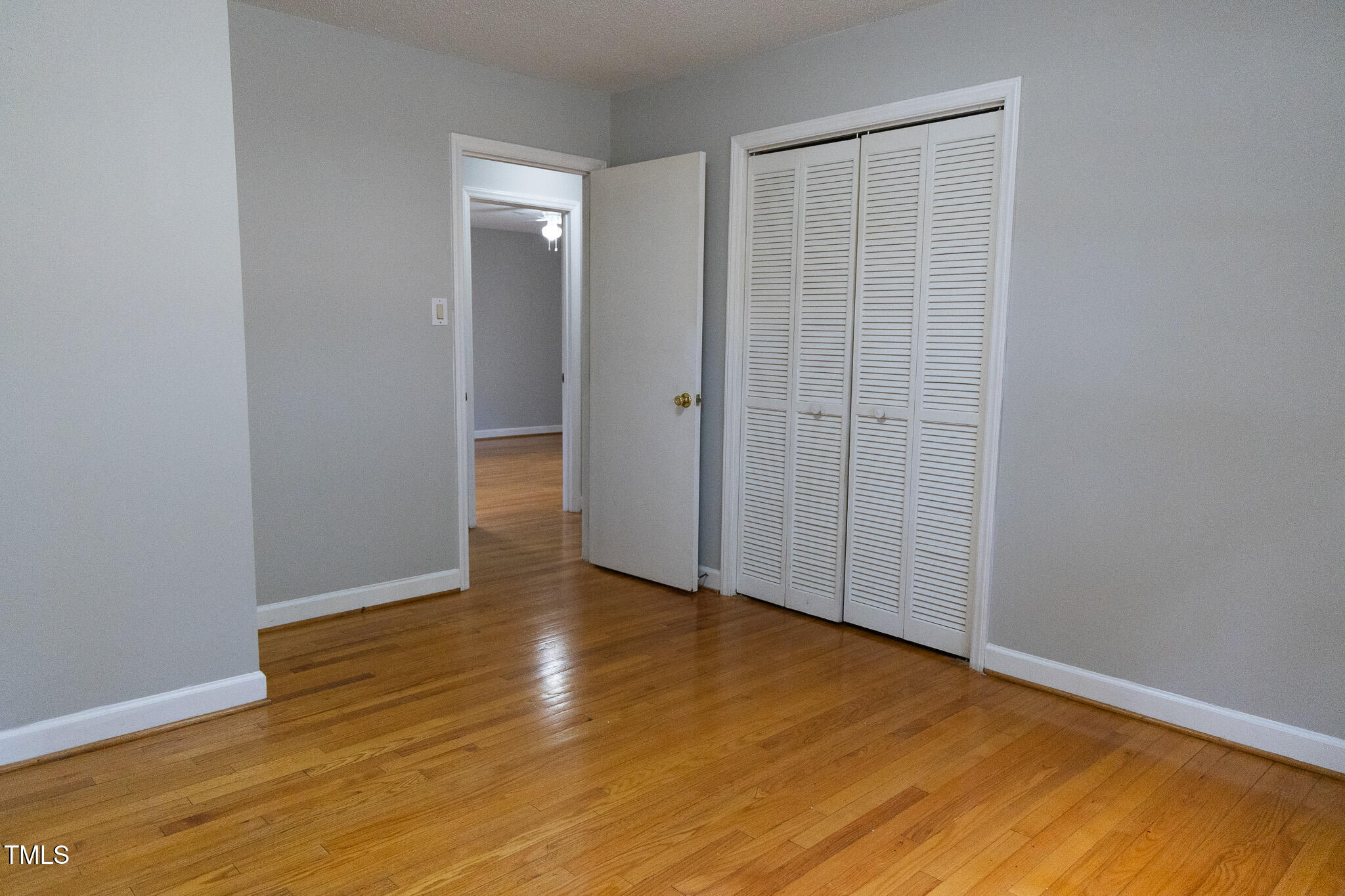 3212 Sparger Road Durham, NC 27705 - Photo 44 of 57 a view of an empty room with wooden floor and a window