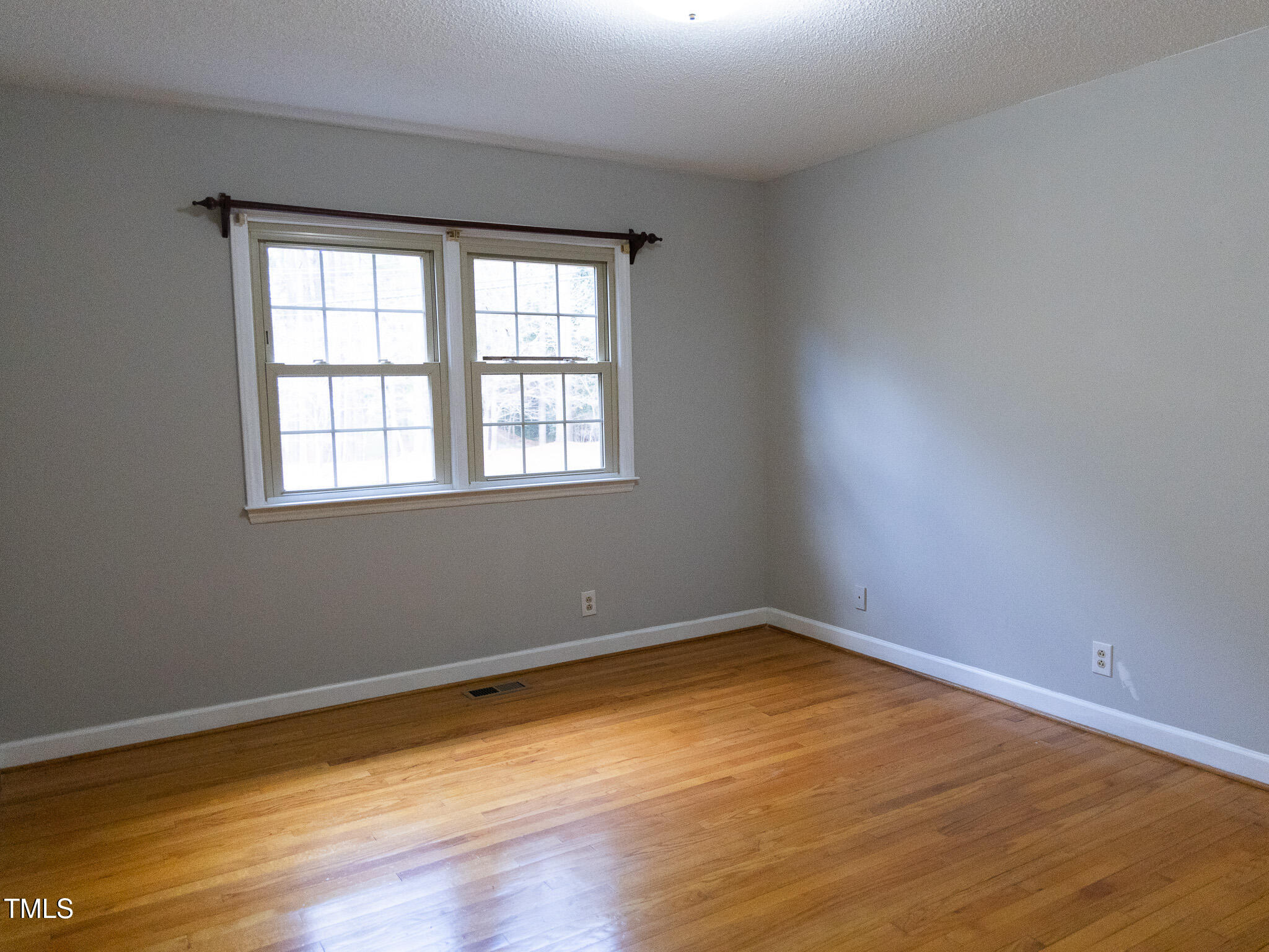 3212 Sparger Road Durham, NC 27705 - Photo 45 of 57 an empty room with wooden floor and windows