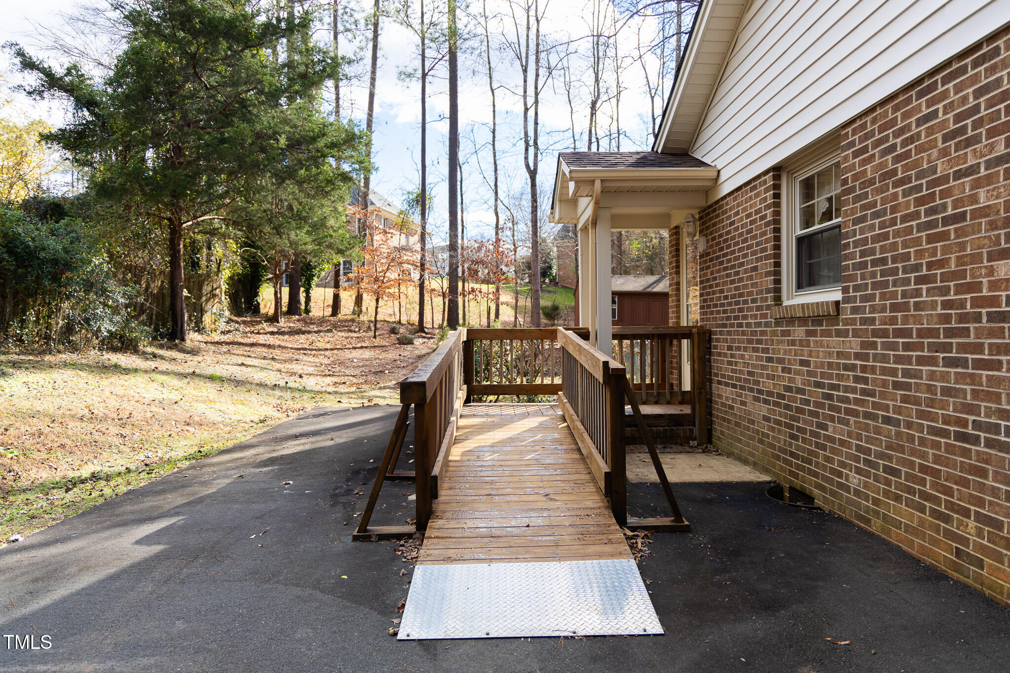3212 Sparger Road Durham, NC 27705 - Photo 6 of 57 a view of a brick house with many windows next to a yard