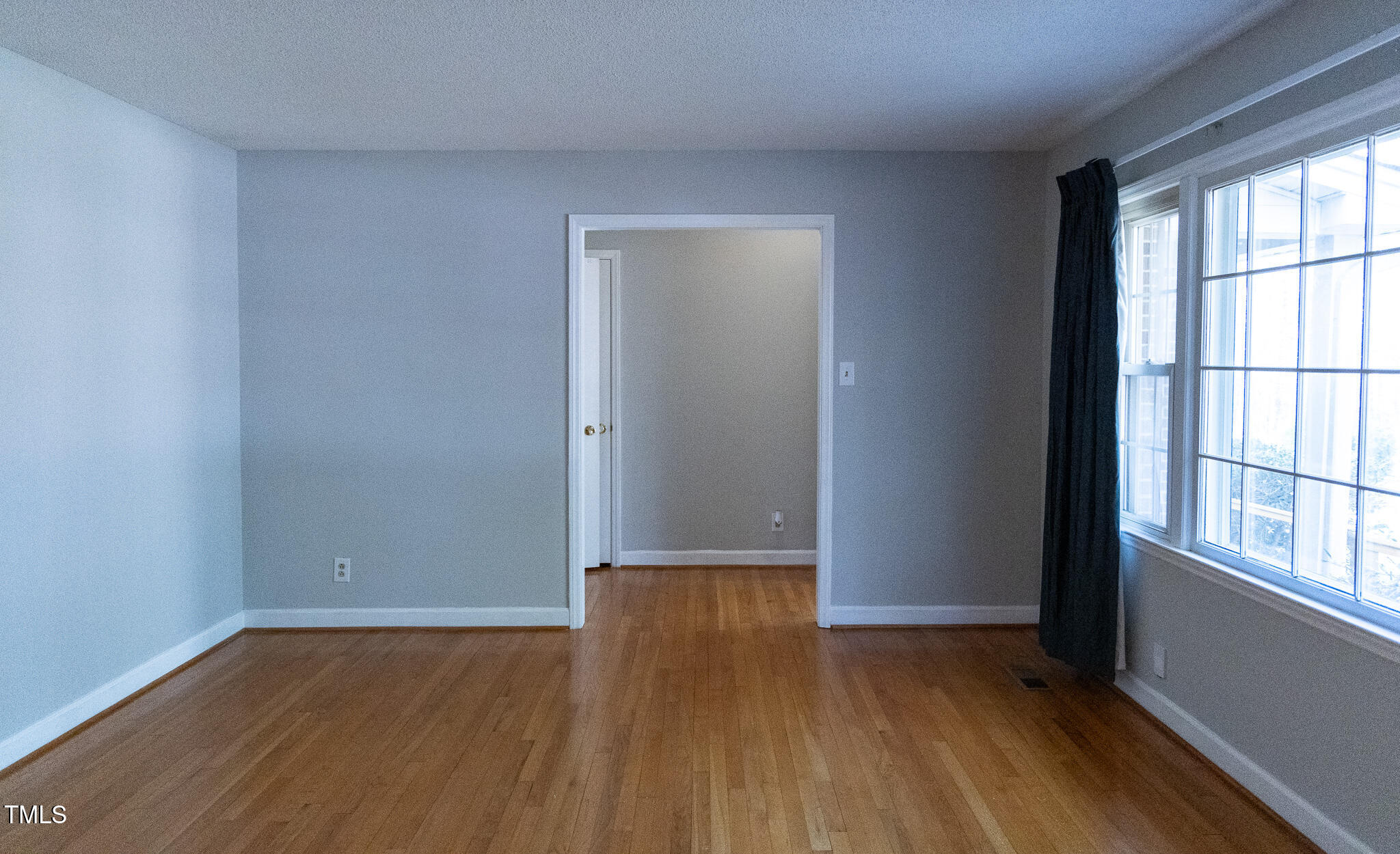 3212 Sparger Road Durham, NC 27705 - Photo 7 of 57 an empty room with wooden floor and windows