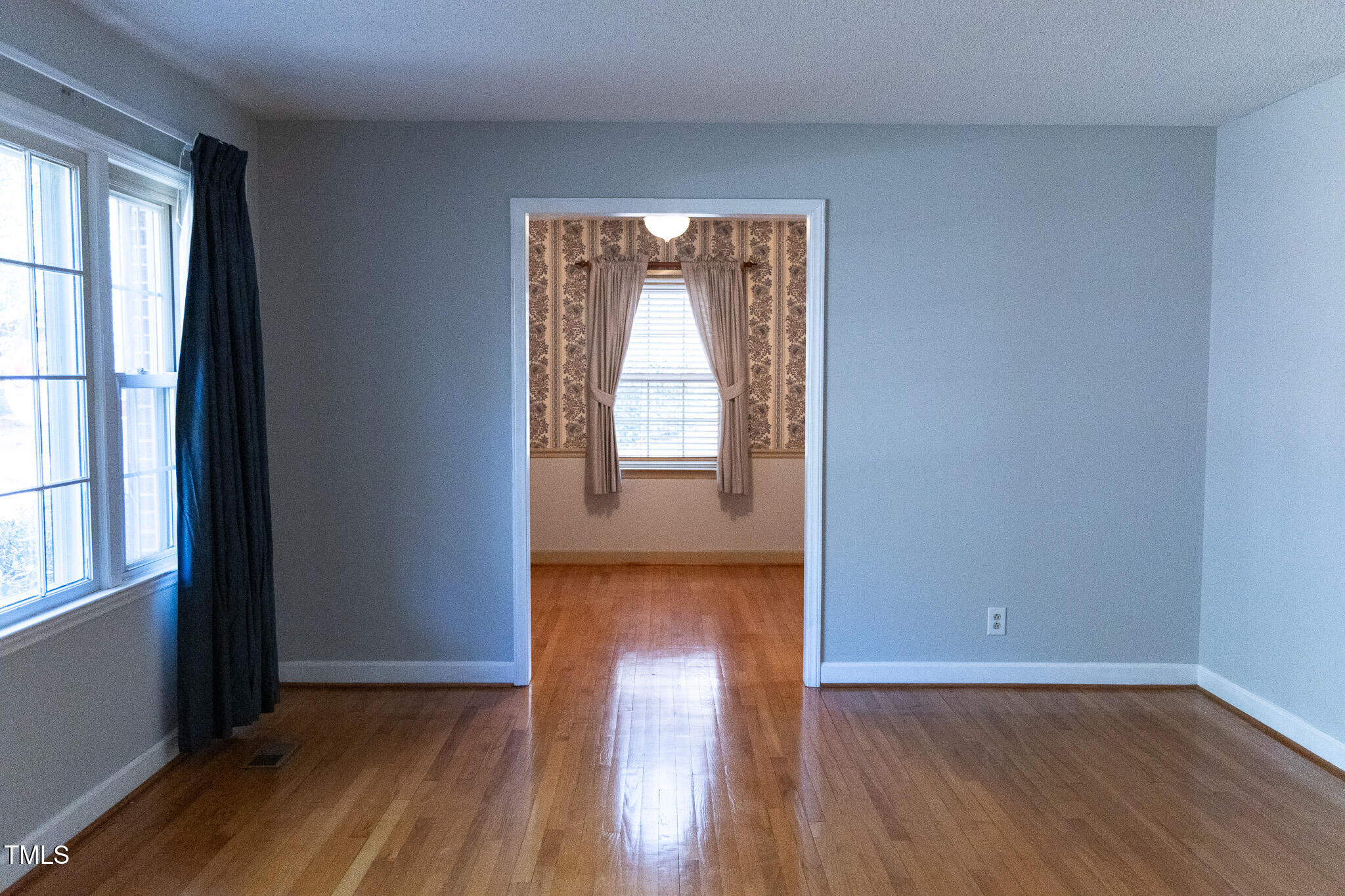 3212 Sparger Road Durham, NC 27705 - Photo 9 of 57 an empty room with wooden floor and windows