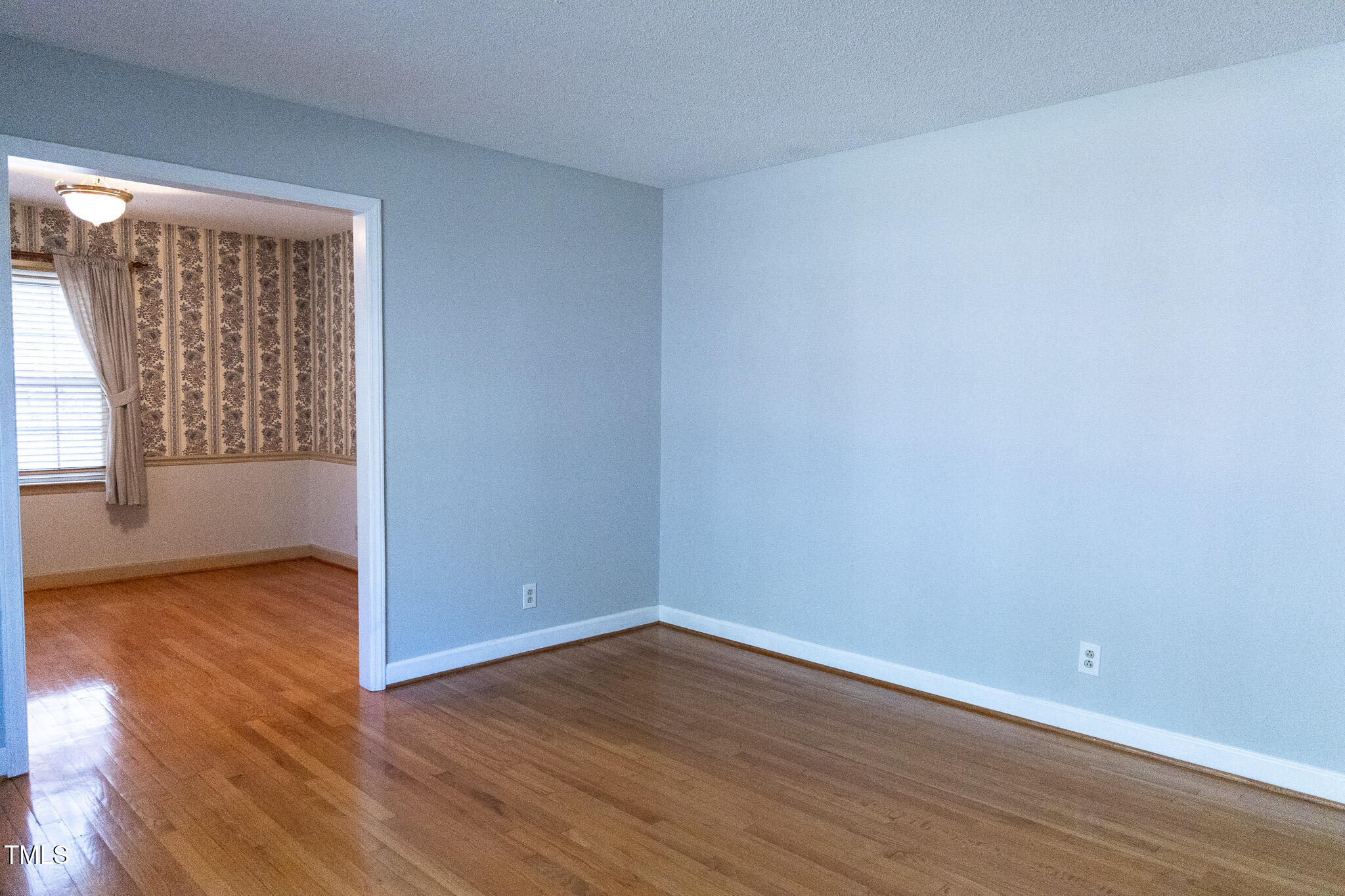 3212 Sparger Road Durham, NC 27705 - Photo 10 of 57 a view of an empty room with wooden floor and a window