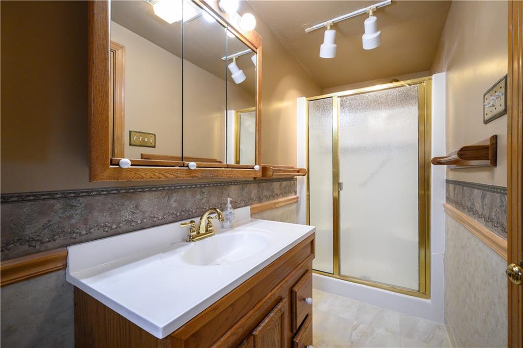 501 Sangree Road Pittsburgh, PA 15237 - Photo 15 of 29 a bathroom with a sink a mirror and a shower