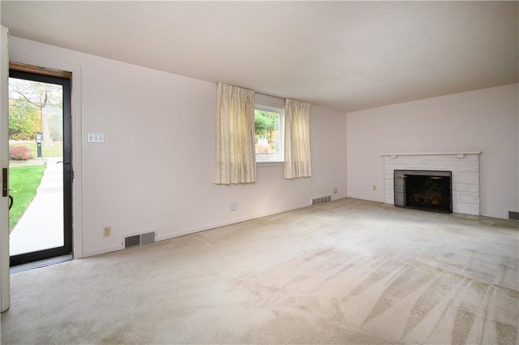 501 Sangree Road Pittsburgh, PA 15237 - Photo 4 of 29 an empty room with windows and fireplace