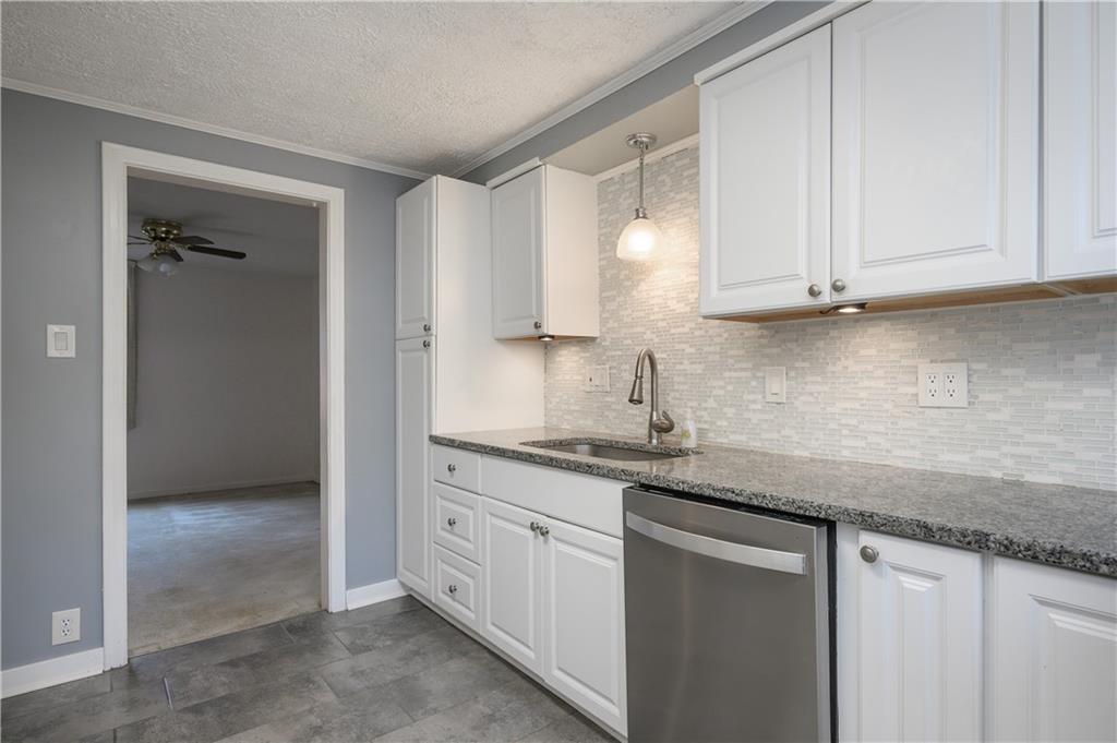 501 Sangree Road Pittsburgh, PA 15237 - Photo 9 of 29 a kitchen with granite countertop white cabinets and a sink