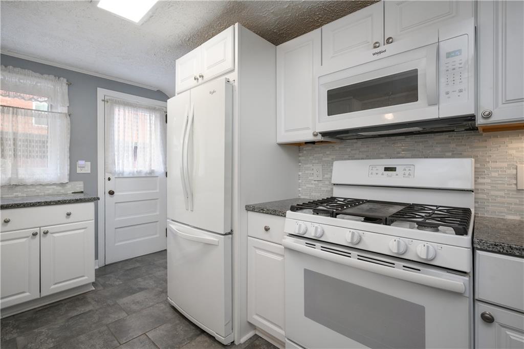 501 Sangree Road Pittsburgh, PA 15237 - Photo 10 of 29 a kitchen with white cabinets and stainless steel appliances
