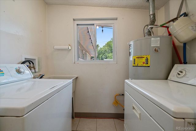 a small garden area with large trees and outdoor seating
