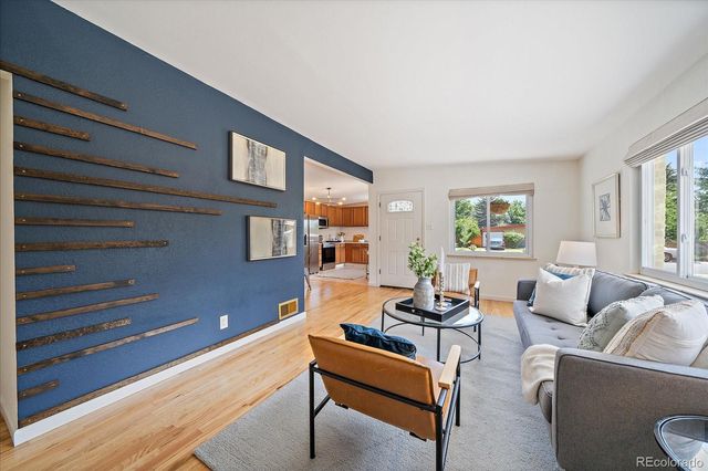 a kitchen with stainless steel appliances a sink a counter top space cabinets and a window