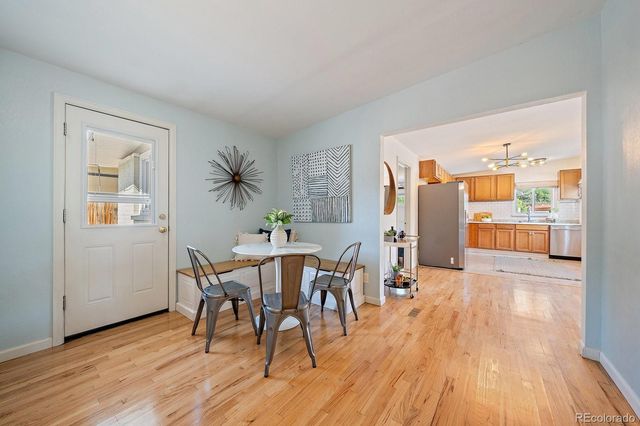 a kitchen with stainless steel appliances granite countertop a stove top oven a refrigerator and cabinets