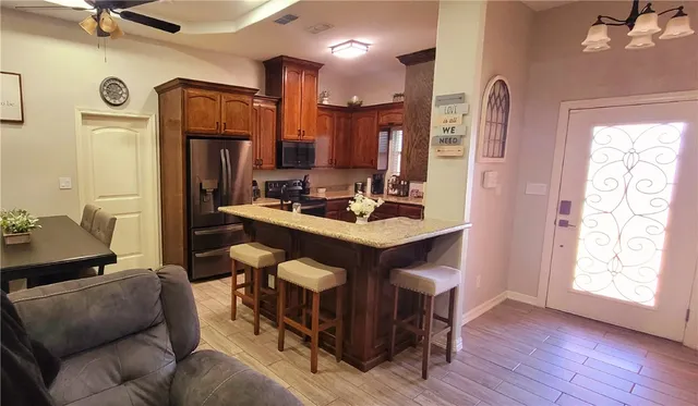 a living room with furniture a large window and a fireplace