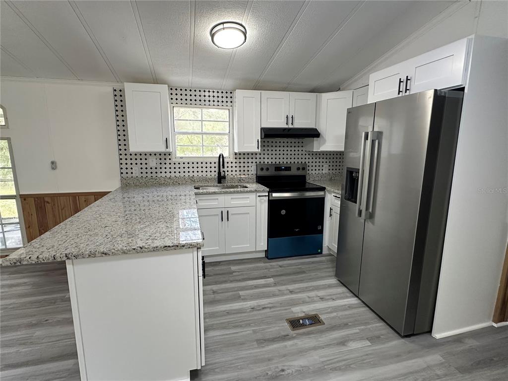 237 North Candle Point Crystal River, FL 34429 - Photo 11 of 21 a kitchen with stainless steel appliances granite countertop a refrigerator sink and stove