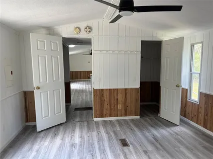 a view of empty room with wooden floor