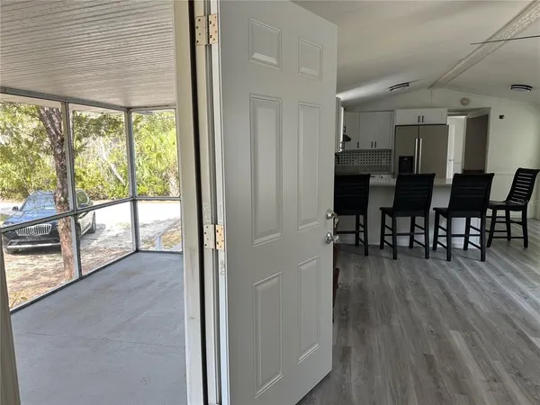 a living room with furniture dining table and a large window
