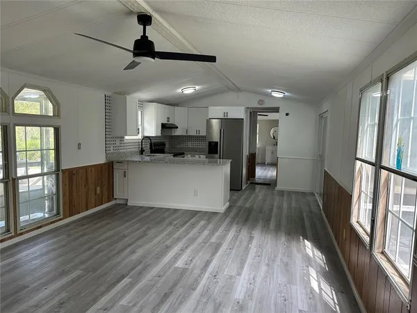 a kitchen with stainless steel appliances granite countertop a refrigerator sink and stove