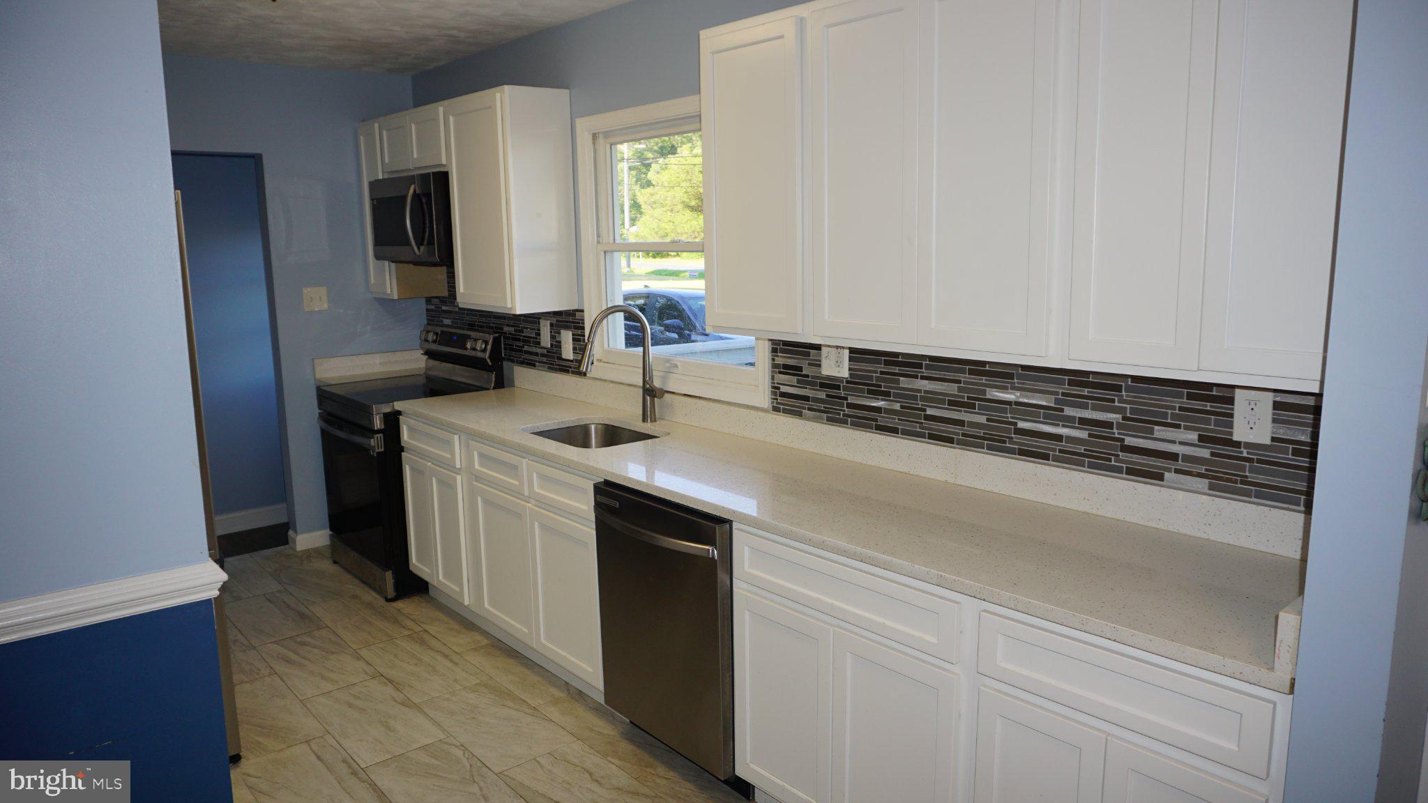 5854 Deale Churchton Road Deale, MD 20751 - Photo 16 of 57 Modern kitchen with sleek finishes.