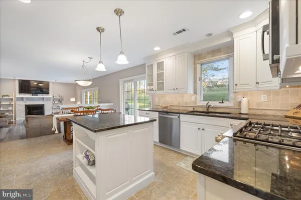 a kitchen with stainless steel appliances granite countertop a stove and a sink