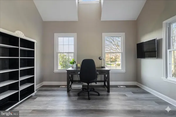 a workspace with furniture window and wooden floor