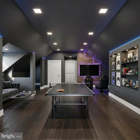 a lobby with furniture and a flat screen tv