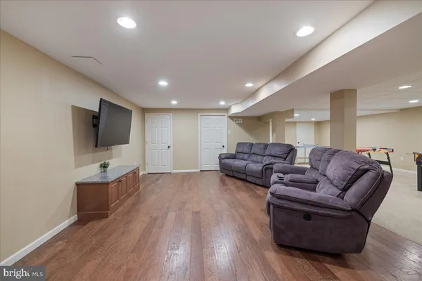 a living room with couches and a flat screen tv