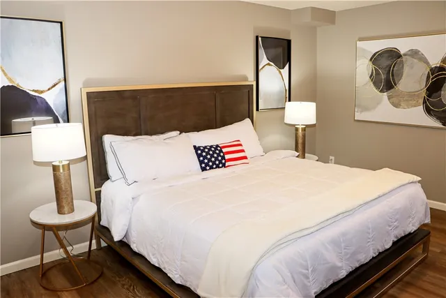 a bedroom with a bed and a lamp