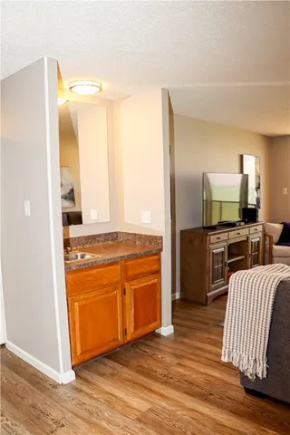 a large kitchen with cabinets wooden floor and stainless steel appliances
