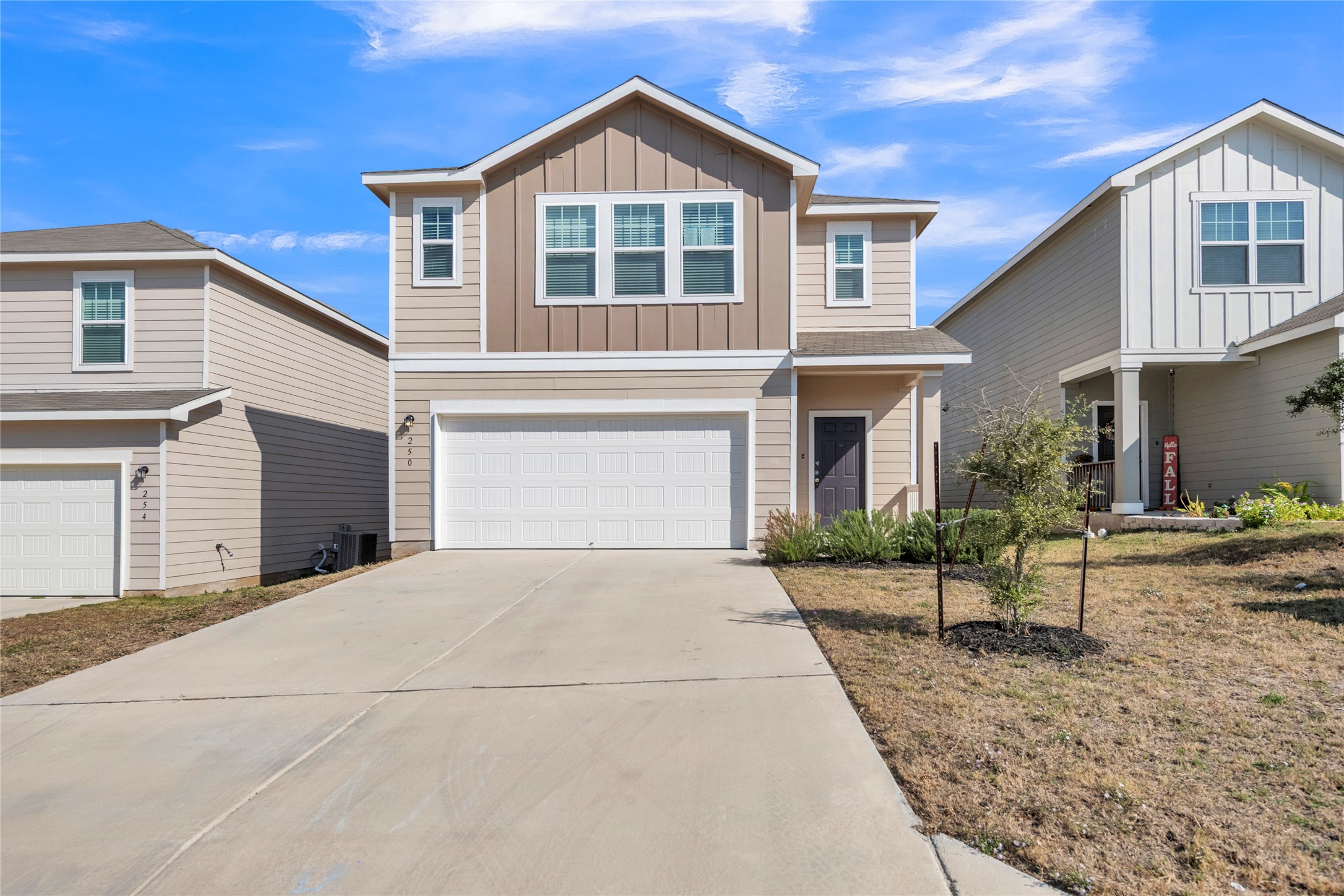 250 Night Riders Way Jarrell, TX 76537 - Photo 1 of 1 View of front of property with board and batten siding, concrete driveway, and a garage