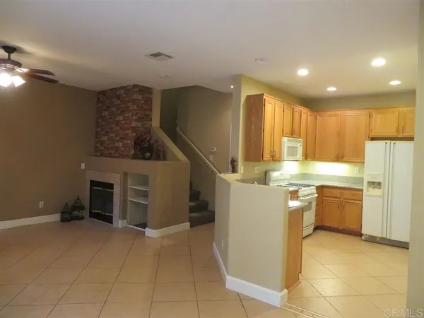 a kitchen with refrigerator and cabinets