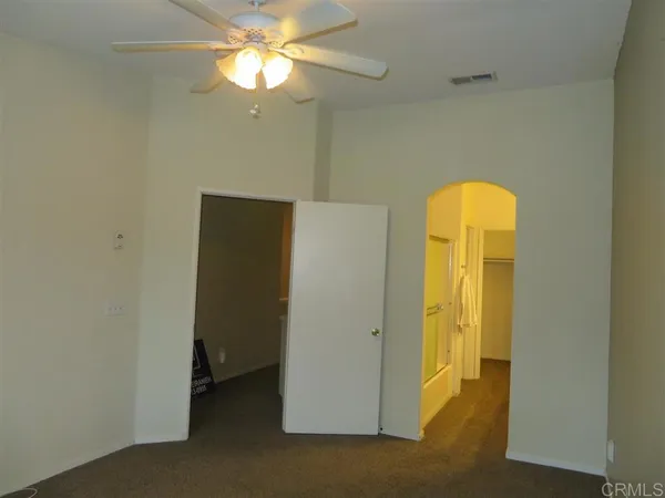 a view of an empty room with a fan
