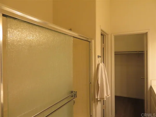 a bathroom with a shower and a glass door