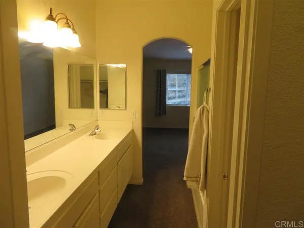 a bathroom with a tub a sink and mirror