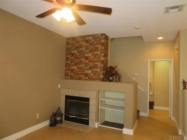 a view of an empty room and fire place