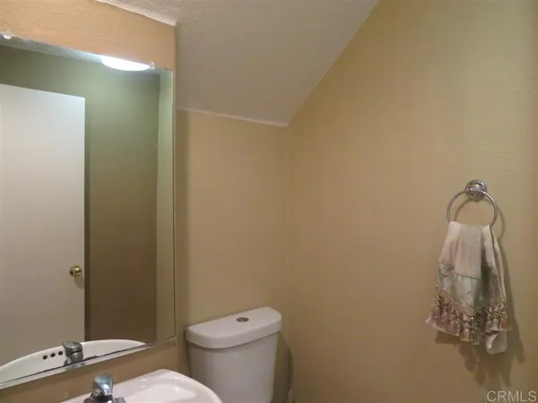 a white toilet sitting next to a shower curtain
