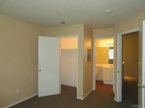 a view of a bathroom with a glass door and a window