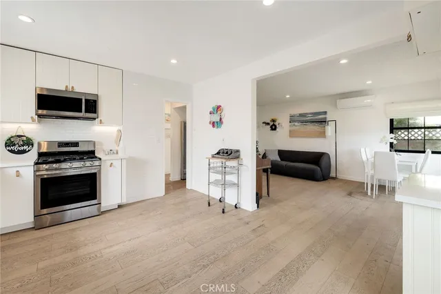 a living room with furniture and a kitchen view