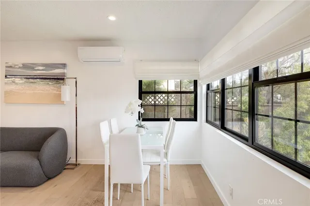 a view of a living room a dining room with furniture and a large window