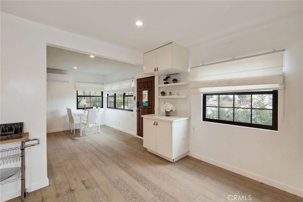 207 South Aviation Boulevard Manhattan Beach, CA 90266 - Photo 9 of 29 a living room with hard wood floors and white walls