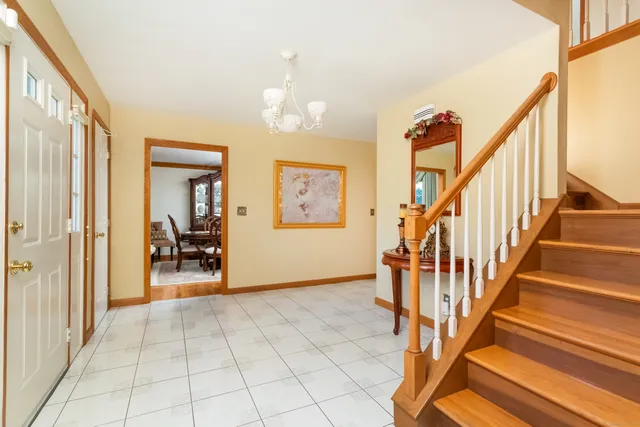 a view of an entryway with wooden floor and livingroom view