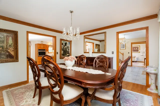 a view of a dining room with furniture and chandelier