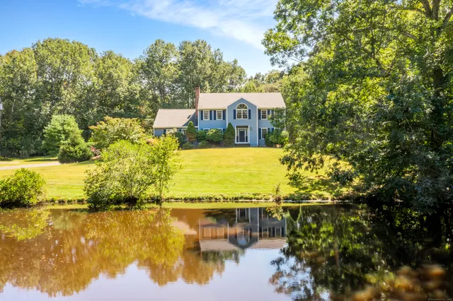 a view of a lake with a house in the background