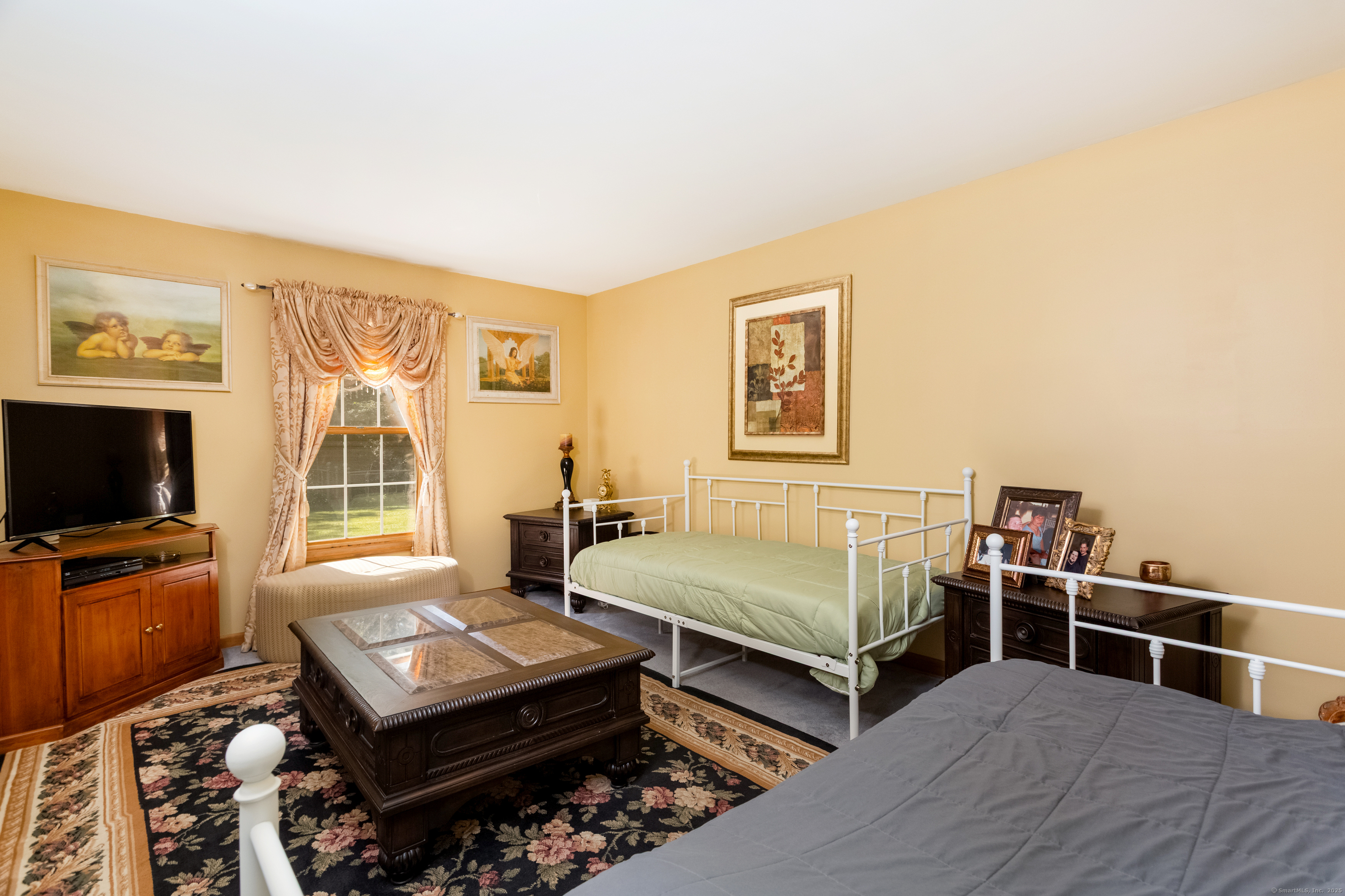 491 Hammertown Road Monroe, CT 06468 - Photo 24 of 40 a bedroom with furniture and a flat screen tv