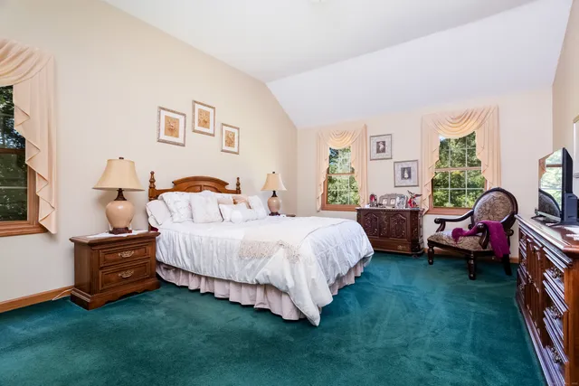 a spacious bedroom with a bed and a window