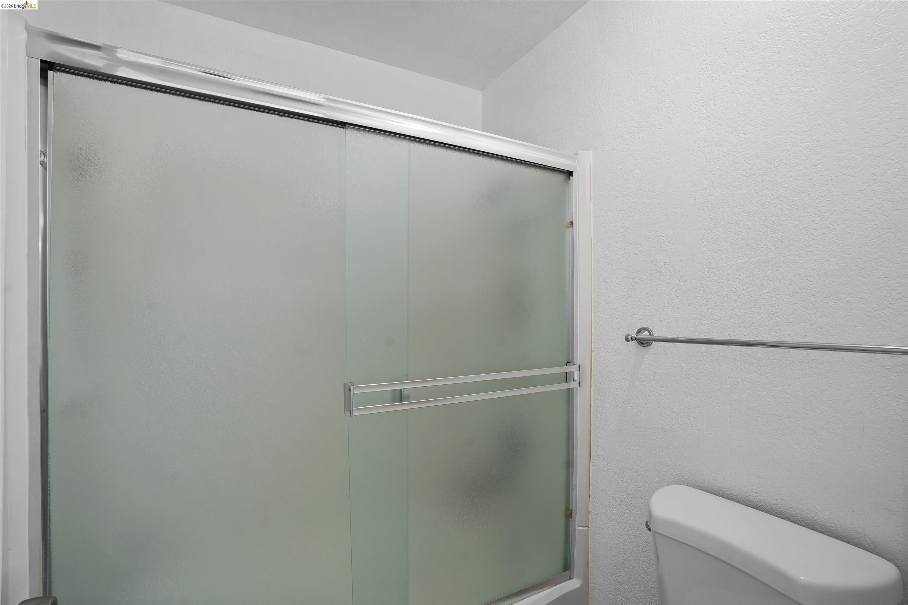 1505 Kirker Pass Road, Unit 214 Concord, CA 94521 - Photo 38 of 55 Shower enclosure featuring frosted glass sliding doors with chrome framing and hardware
