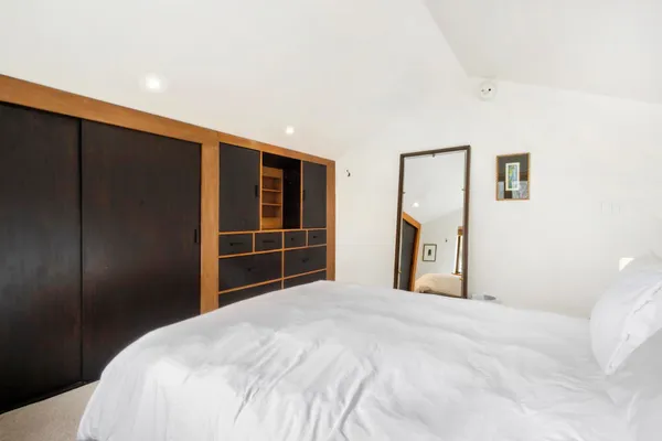 a bedroom with a bed and a closet