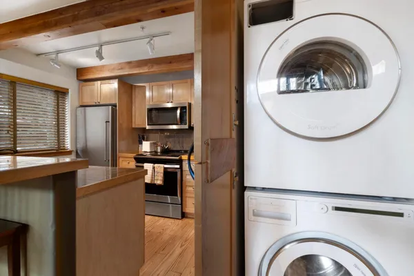 a view of a kitchen with a washer and dryer