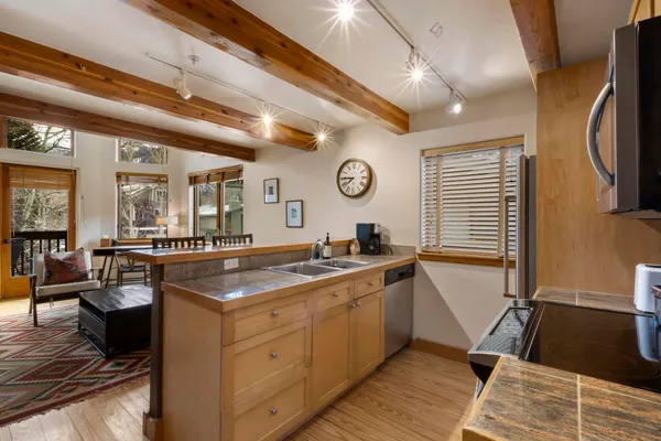 a kitchen with a sink and wooden cabinets