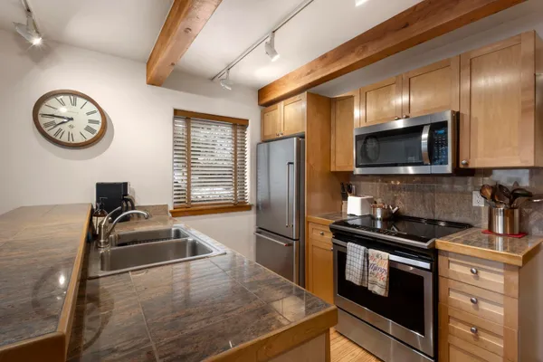 a kitchen with a refrigerator and a sink