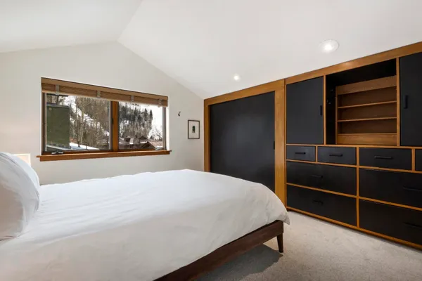 a bedroom with a bed and a window