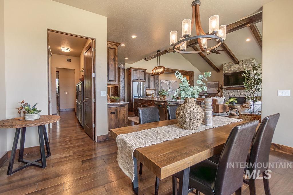 15350 Syrah Court Caldwell, ID 83607 - Photo 24 of 50 Dining area featuring a wood-finish table, a decorative chandelier, and wood-finish flooring