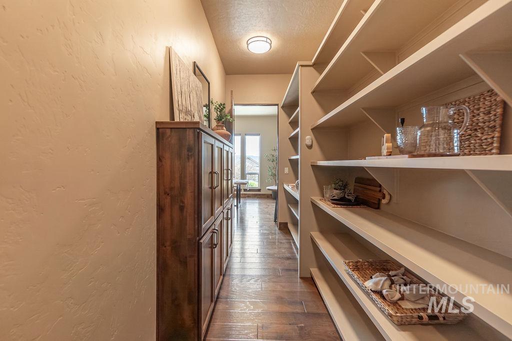 15350 Syrah Court Caldwell, ID 83607 - Photo 25 of 50 Expansive pantry hallway featuring built-in shelving, wood-finish flooring, and a recessed ceiling light
